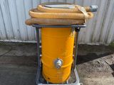 a yellow drum with a hose attached to it