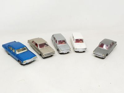 several toy cars are lined up in a row on a white surface