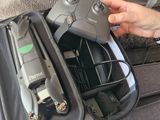 a person that is holding a remote control in a bag