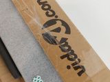 someone is cutting a piece of paper with a knife on top of a cardboard box