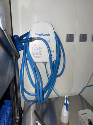 a blue hose attached to the side of a refrigerator