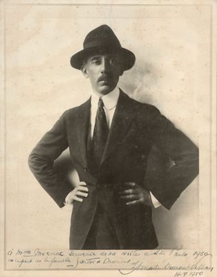 a black and white photo of a man in a suit and hat