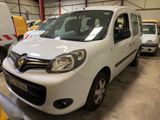 une camionnette blanche garée dans un garage avec d'autres véhicules