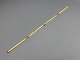 an old brass pipe with a wooden handle on a gray background