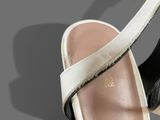 a close up of a pair of sandals on a gray surface