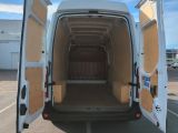 the back of a white van with its doors open in a parking lot