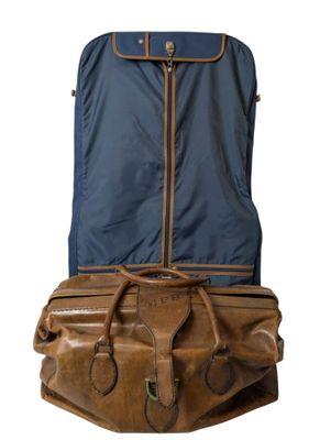 a brown suitcase with a blue cover on top of it