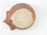 a brown vase on a white surface with a white background
