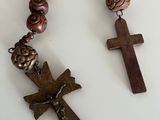 a close up of a rosary and a cross on a table