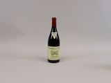 une bouteille de vin à côté d'un verre de vin