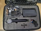 a case that has a microphone, a microphone, and other items in it