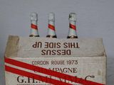 three bottles of beer in a wooden box on a table