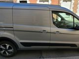 a silver van that is parked on the side of the street