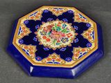 an image of a blue and gold plate with a flower design on it