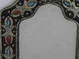an image of a mirror hanging on a wall with a tag on it
