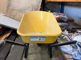 a yellow wheelbarrow in the middle of a pile of wood