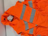 an orange jacket with reflective stripes laying on a white surface