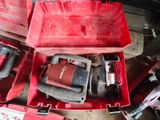 a red tool box with tools in it on the floor