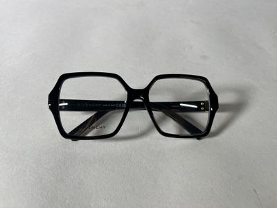 black glasses on a white surface with a white background