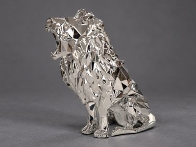 an image of a silver sculpture of a dog sitting on its hind legs