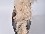 a black shoe with a feather on the top of it