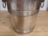 silver plated ice bucket with handles on wooden table