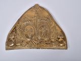 a gold plate with a crown on it on a white surface