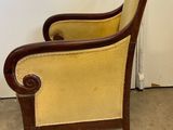an image of a chair with a yellow upholstered back and arms