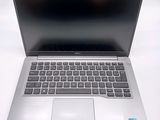 a silver laptop computer sitting on top of a white table