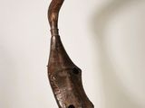 statue of a bird made of wood on a stand in a room