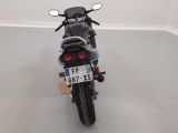a motorcycle parked in a room with a number plate on the back