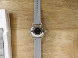 a watch that is sitting on a table next to a keyboard