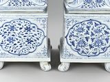 two blue and white vases sitting on top of each other