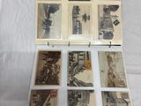an old photo of a collection of old postcards sitting on a table