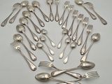 a lot of silver spoons and forks arranged in a circle