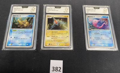 three pokemon cards are sitting on a table with a price tag
