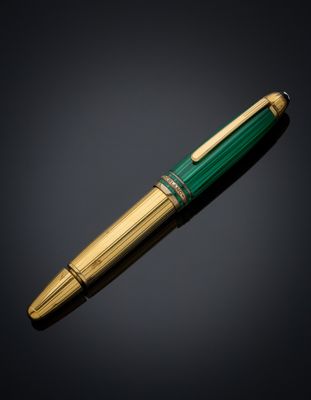 a green and gold pen with a gold tip