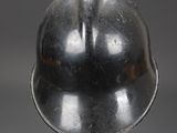 silver helmet on a black base on a gray background