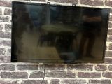 a flat screen tv mounted on a brick wall