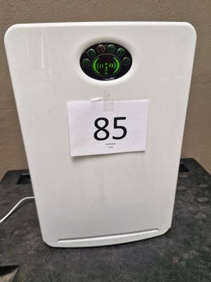 a white refrigerator sitting on a table with a sign on it