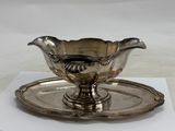 a silver plate with a saucer and a saucer on it