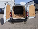 a white van with its doors open in a parking lot