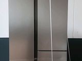 two refrigerators that are sitting on a pallet in a room