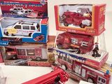 a lot of toy firetrucks and other toys on the table