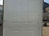 a white door sitting on top of a pallet in a parking lot