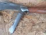 a knife that is laying on top of a piece of wood