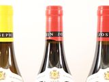 three bottles of wine sitting next to each other on a table