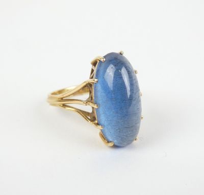 une bague en or avec une pierre bleue au centre