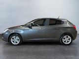 the grey car is parked in a room with a gray wall
