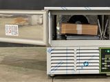 a machine that is sitting on the ground with a box inside of it